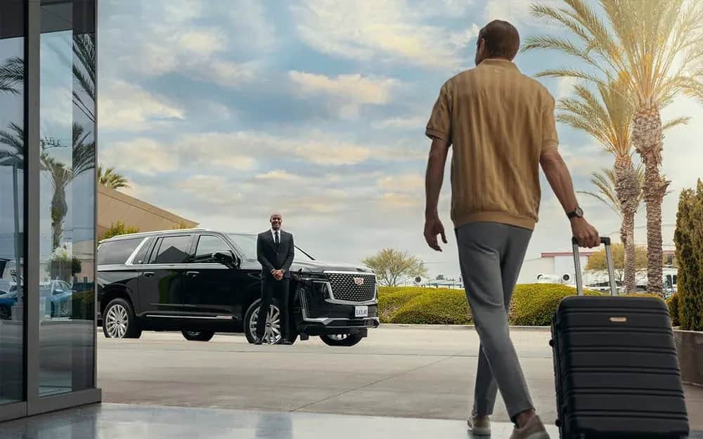 Traveler approaching a private car and waiting chauffeur